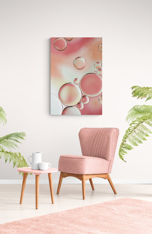 Experience captivating contemporary abstract art with "Blossoms 3." This gallery-quality macro photograph showcases the vibrant interplay of oil and water set against a colorful backdrop, offering a symphony of colors and intricate patterns. Standalone or paired with other Blossoms pieces, it's available as a long-lasting acrylic photo print. Perfect for enhancing your living or office space and inspiring conversations. Image shows Blossoms 3 hanging in living room with pink chair and coffee table.