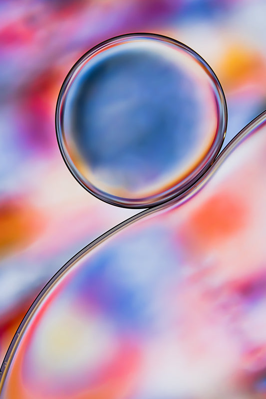 Discover "Circus 3," a mesmerizing macro abstract photograph capturing the dynamic play of oil and water. Elevate your space with vibrant colors and fluid textures that transport you to an otherworldly realm. Perfect for diptych or triptych arrangements alongside 'Circus 1' and 'Circus 2,' this acrylic print adds a burst of abstract vibrancy to your wall decor. Explore sizes to suit your style. Inquire about custom options.