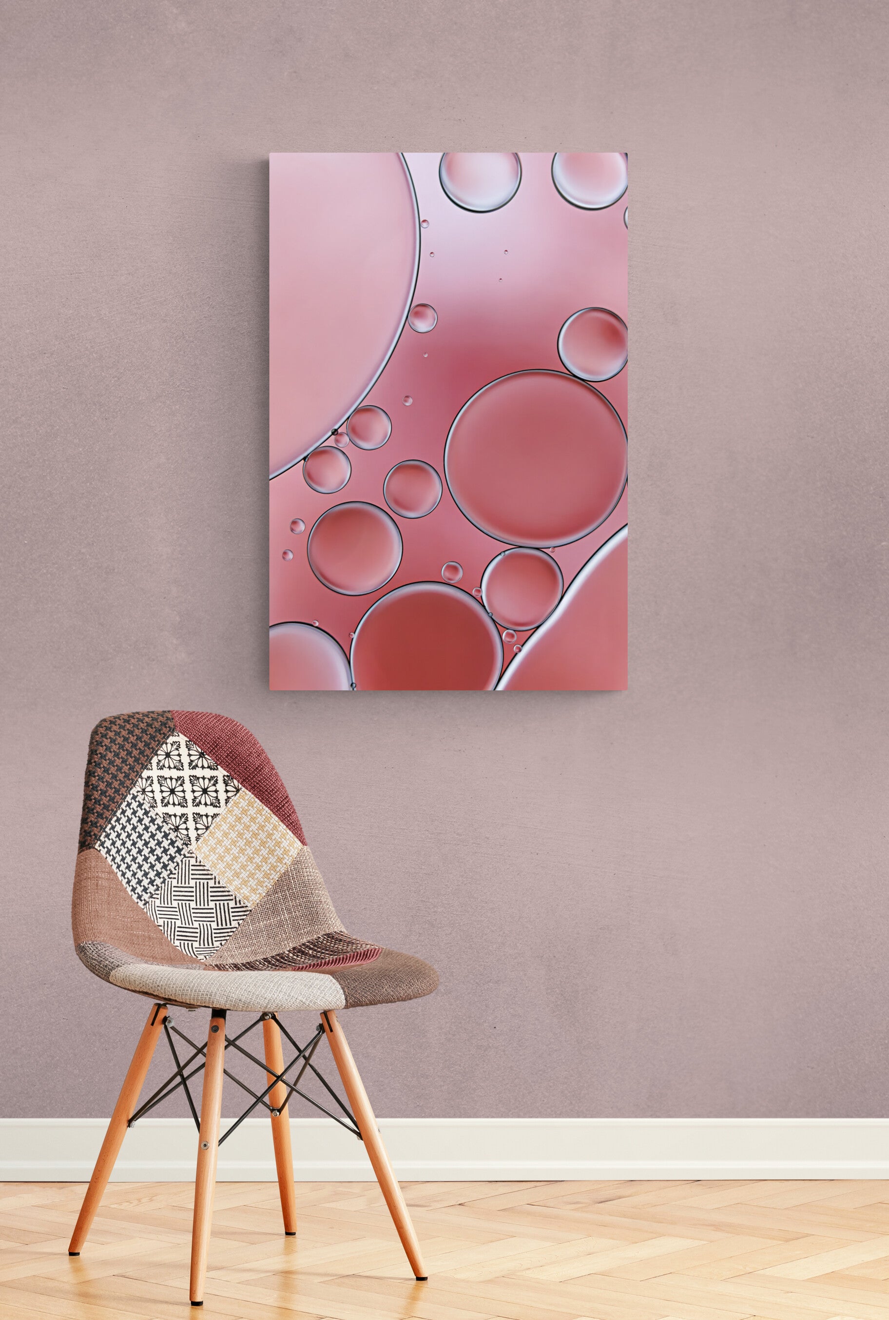 "Cozy Coral 1" is a contemporary acrylic wall art piece. It features an abstract, modern design with captivating coral colors and intricate textures created using oil and water. A visually engaging addition to any space. "Cozy Coral 1" is shown hanging on a wall with a patterned chair nearby.