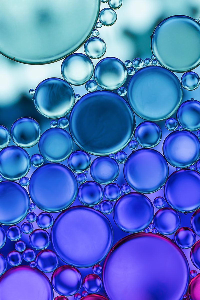 "Deep Waters" - Abstract macro photograph showcasing the convergence of oil and water in vivid colors, evoking oceanic depths and hidden currents. Gallery-quality acrylic print with captivating visual appeal for home or office.