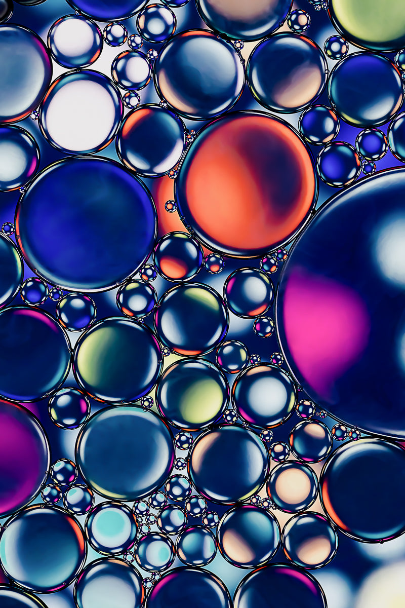 "Disco Denims" Macro Oil and Water Photograph: A contemporary artwork featuring swirling hues resembling disco lights against denim. "Disco Denims" is a gallery quality fine art acrylic photo print available in various sizes.
