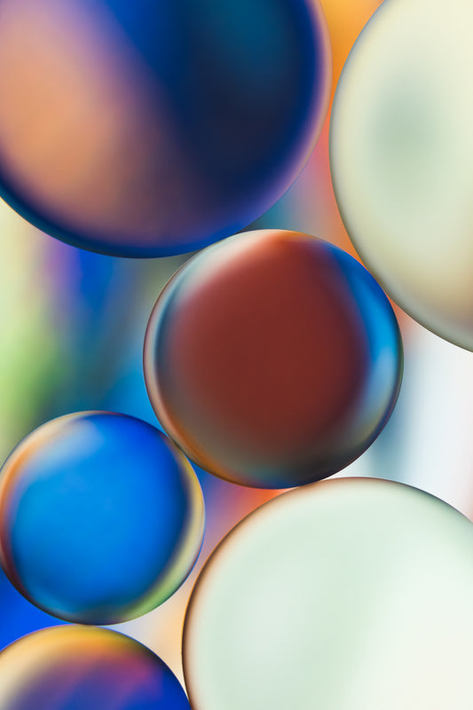 "Mosaic Memories 3" is a stunning macro photograph blending oil and water into an abstract pattern. The primary colors are blue, white, brown, orange and green. This contemporary fine art piece is perfect as vibrant wall art, printed on metallic paper and mounted to acrylic for depth and brilliance. A unique, modern addition to any home, office, or gallery.