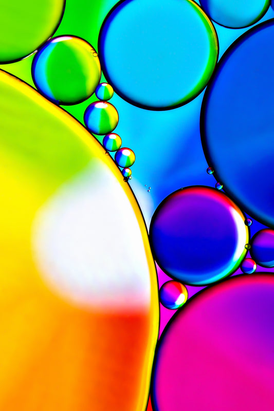 "Rainbow 1": Abstract photograph capturing the vibrant convergence of oil and water, creating a symphony of colors resembling a rainbow spectrum. Mesmerizing textures and captivating swirls invite exploration and contemplation of this unique wall art. Gallery-quality fine art acrylic print with  modern frameless display.  Celebrates fusion of color and form in captivating composition. Available in various sizes.