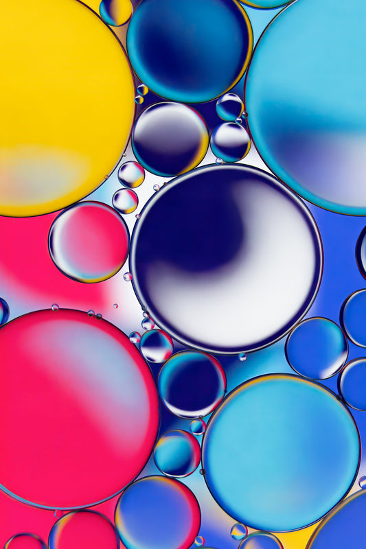 Abstract acrylic print titled 'School Daze.' Features a macro view of oil and water creating a colorful, psychedelic pattern. The image showcases a mix of vibrant colors and fluid shapes, symbolizing modern creativity. Ideal as unique, contemporary wall art for various spaces.